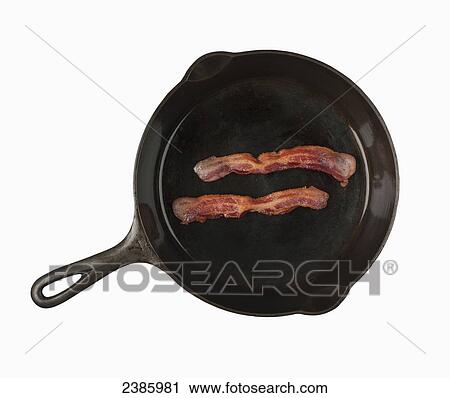 Stock Image - Bacon in a frying pan. Fotosearch