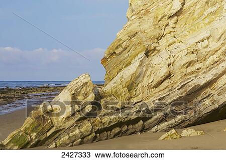 Stock Image - Beach rock with volcanic striations; Santa Barbara, California, United States of America. Fotosearch