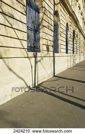 Stock Image - Blue grates on windows along a building in the historical district of the Marais; Paris, France. Fotosearch