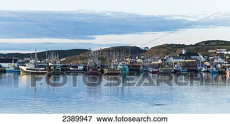 Stock Photo - Boats in the harbour of a fishing village along the coast; Twillingate, Newfoundland and Labrador, Canada. Fotosearch