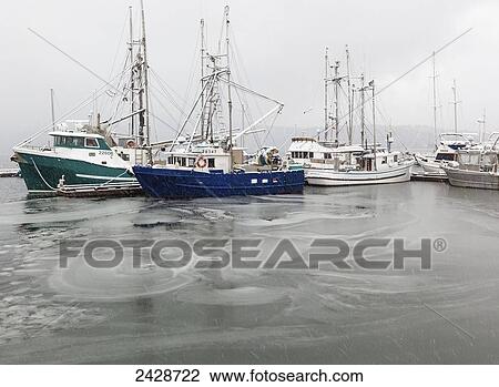 Boats sit at dock as ice covers the waters in the seaside village of Cowichan Bay on Vancouver Island; Duncan, British Columbia, Canada View Large Photo Image Stock Image - Boats sit at dock as ice covers the waters in the seaside village of Cowichan Bay on Vancouver Island; Duncan, British Columbia, Canada. Fotosearch
