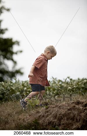 Boy Running Uphill In Field, Ontario View Large Photo Image Stock Photo - Boy Running Uphill In Field, Ontario. Fotosearch