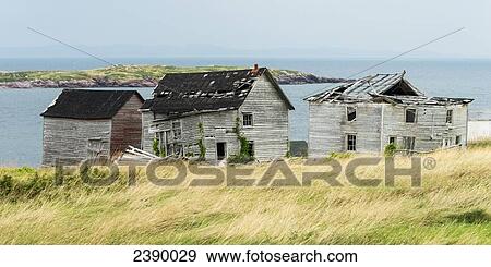 Broken and abandoned wooden houses along the water's edge of the atlantic coast; Plate Cove East, Newfoundland and Labrador, Canada View Large Photo Image Stock Photo - Broken and abandoned wooden houses along the water's edge of the atlantic coast; Plate Cove East, Newfoundland and Labrador, Canada. Fotosearch