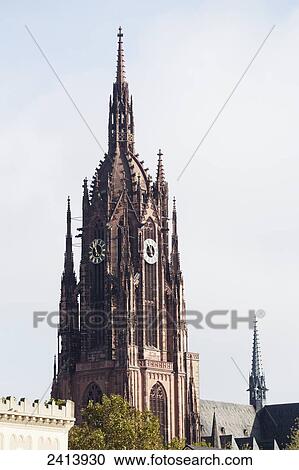Stock Image - Cathedral tower with blue sky and clouds; Frankfurt am Main, Germany. Fotosearch