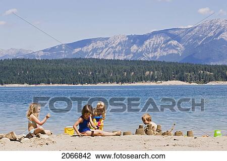 Children Playing On Beach On Lake Koocanusa In The East Kootenays Near Fernie, British Columbia, Canada View Large Photo Image Stock Image - Children Playing On Beach On Lake Koocanusa In The East Kootenays Near Fernie, British Columbia, Canada. Fotosearch