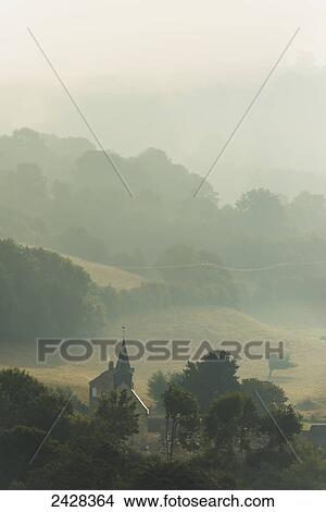 Church and house of Le Vey on misty morning, near Clecy; Swiss Normandy, Normandy, France View Large Photo Image Picture - Church and house of Le Vey on misty morning, near Clecy; Swiss Normandy, Normandy, France. Fotosearch