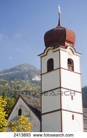 Church steeple with dome top and gold cross with blue sky and tree covered mountain peak in autumn; View Large Photo Image Stock Image - Church steeple with dome top and gold cross with blue sky and tree covered mountain peak in autumn; . Fotosearch
