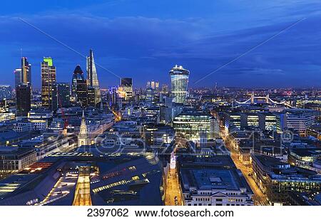 Stock Image - Cityscape of London with various buildings in the skyline at dusk; London, England. Fotosearch