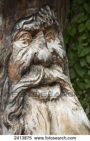 Stock Photography - Close up of a detailed tree trunk face carving; Lanserbach, Austria. Fotosearch