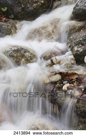 Close up of creek waterfalls flowing over rocks; Brandenberg, Austria View Large Photo Image Picture - Close up of creek waterfalls flowing over rocks; Brandenberg, Austria. Fotosearch