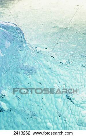 Close up of ice surface of iceberg broken off Mendenhall Glacier floating in Mendenhall lake, flipping over and exposing blue polished ice from being underwater; Juneau, Alaska, United States of America View Large Photo Image Stock Image - Close up of ice surface of iceberg broken off Mendenhall Glacier floating in Mendenhall lake, flipping over and exposing blue polished ice from being underwater; Juneau, Alaska, United States of America. Fotosearch