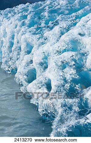 Close up of ice surface of iceberg broken off Mendenhall Glacier floating in Mendenhall lake, flipping over and exposing blue polished ice from being underwater; Juneau, Alaska, United States of America View Large Photo Image Stock Image - Close up of ice surface of iceberg broken off Mendenhall Glacier floating in Mendenhall lake, flipping over and exposing blue polished ice from being underwater; Juneau, Alaska, United States of America. Fotosearch