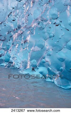 Close up of ice surface of iceberg broken off Mendenhall Glacier floating in Mendenhall lake, flipping over and exposing blue polished ice from being underwater; Juneau, Alaska, United States of America View Large Photo Image Stock Photo - Close up of ice surface of iceberg broken off Mendenhall Glacier floating in Mendenhall lake, flipping over and exposing blue polished ice from being underwater; Juneau, Alaska, United States of America. Fotosearch