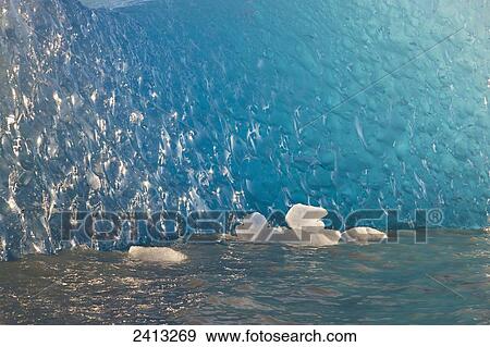 Close up of ice surface of iceberg broken off Mendenhall Glacier floating in Mendenhall lake, flipping over and exposing blue polished ice from being underwater; Juneau, Alaska, United States of America View Large Photo Image Stock Photo - Close up of ice surface of iceberg broken off Mendenhall Glacier floating in Mendenhall lake, flipping over and exposing blue polished ice from being underwater; Juneau, Alaska, United States of America. Fotosearch