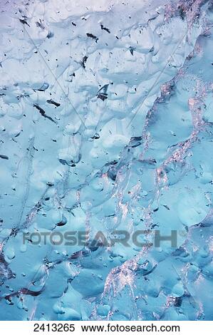 Close up of ice surface of iceberg broken off Mendenhall Glacier floating in Mendenhall lake, flipping over and exposing blue polished ice from being underwater; Juneau, Alaska, United States of America View Large Photo Image Stock Photography - Close up of ice surface of iceberg broken off Mendenhall Glacier floating in Mendenhall lake, flipping over and exposing blue polished ice from being underwater; Juneau, Alaska, United States of America. Fotosearch