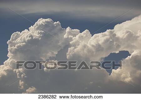 Close up of storm clouds with an unique formation and hole with blue sky; Calgary, Alberta, Canada View Large Photo Image Stock Image - Close up of storm clouds with an unique formation and hole with blue sky; Calgary, Alberta, Canada. Fotosearch