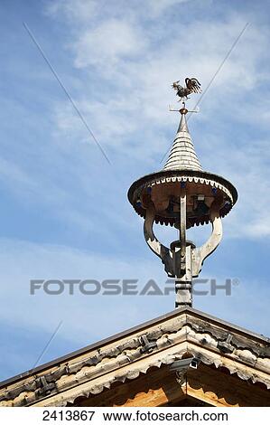 Close up of wooden alpine building peak with wooden ornament and blue sky and clouds (small bell tower); Hintertux, Austria View Large Photo Image Stock Photo - Close up of wooden alpine building peak with wooden ornament and blue sky and clouds (small bell tower); Hintertux, Austria. Fotosearch