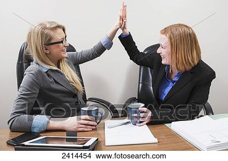 Co-workers celebrate teamwork and accomplishments; Edmonton, Alberta, Canada View Large Photo Image Picture - Co-workers celebrate teamwork and accomplishments; Edmonton, Alberta, Canada. Fotosearch