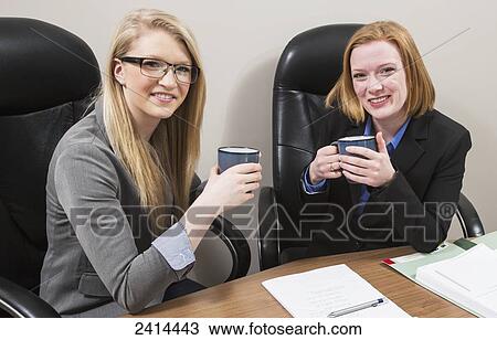 Co-workers relaxing over a coffee during a work day; Edmonton, Alberta, Canada View Large Photo Image Stock Image - Co-workers relaxing over a coffee during a work day; Edmonton, Alberta, Canada. Fotosearch