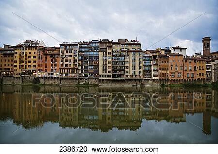 Colourful residential buildings along the shoreline reflected in the water; Florence, Tuscany, Italy View Large Photo Image Stock Image - Colourful residential buildings along the shoreline reflected in the water; Florence, Tuscany, Italy. Fotosearch