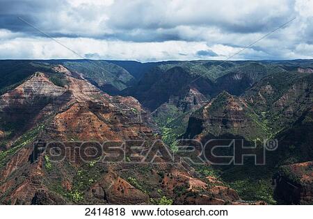 Colourful rock in Waimea Canyon; Kauai, Hawaii, United States of America View Large Photo Image Stock Photo - Colourful rock in Waimea Canyon; Kauai, Hawaii, United States of America. Fotosearch