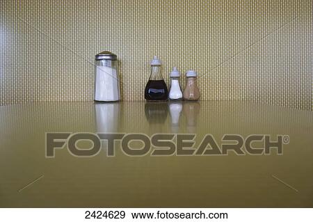 Condiments lined up on a restaurant table; London, England View Large Photo Image Stock Photo - Condiments lined up on a restaurant table; London, England. Fotosearch