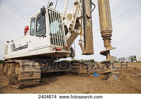 Construction project drilling pilings for warehouse development; Edmonton, Alberta, Canada View Large Photo Image Picture - Construction project drilling pilings for warehouse development; Edmonton, Alberta, Canada. Fotosearch