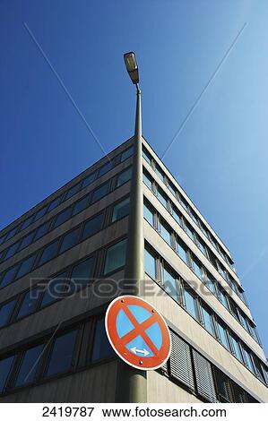 Corner of a building with a sign on a street light pole indicating no stopping; Hamberg, Germany View Large Photo Image Stock Photo - Corner of a building with a sign on a street light pole indicating no stopping; Hamberg, Germany. Fotosearch