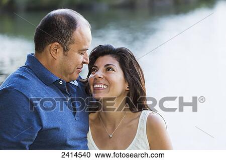 Stock Image - Couple spending quality time together in a park; Edmonton, Alberta, Canada. Fotosearch