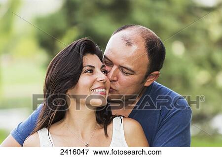 Couple spending quality time together in a park; Edmonton, Alberta, Canada View Large Photo Image Stock Photo - Couple spending quality time together in a park; Edmonton, Alberta, Canada. Fotosearch