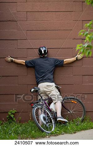 Cyclist crashing into a wall on a bike path; Edmonton, Alberta, Canada View Large Photo Image Stock Photo - Cyclist crashing into a wall on a bike path; Edmonton, Alberta, Canada. Fotosearch