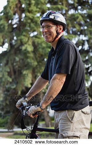 Cyclist using an electric bike; Edmonton, Alberta, Canada View Large Photo Image Stock Image - Cyclist using an electric bike; Edmonton, Alberta, Canada. Fotosearch