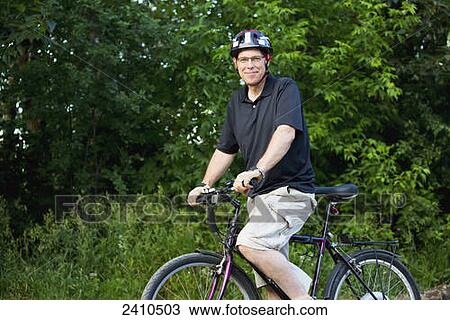 Cyclist using an electric bike; Edmonton, Alberta, Canada View Large Photo Image Stock Image - Cyclist using an electric bike; Edmonton, Alberta, Canada. Fotosearch