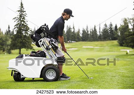 Stock Image - Disabled golfer in a tournament using high tech mobility aid; Edmonton, Alberta, Canada. Fotosearch