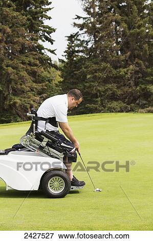 Stock Photo - Disabled golfer in a tournament using high tech mobility aid; Edmonton, Alberta, Canada. Fotosearch