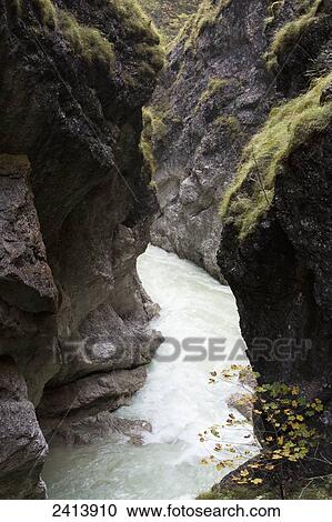Dramatic rocky gorge with winding river; Brandenberg, Austria View Large Photo Image Stock Image - Dramatic rocky gorge with winding river; Brandenberg, Austria. Fotosearch