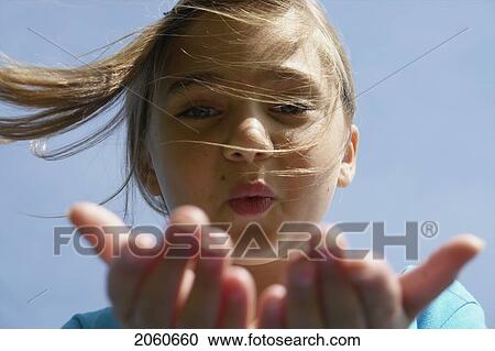 Eight Year Old Girl Blowing Toward Camera, Winnipeg, Canada View Large Photo Image Stock Image - Eight Year Old Girl Blowing Toward Camera, Winnipeg, Canada. Fotosearch