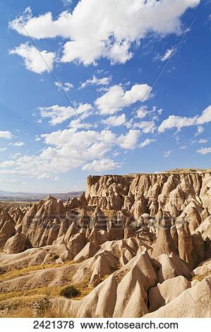 Fairy chimneys and cliffs in a rugged, barren landscape in Deverent Valley; Cappadocia, Turkey View Large Photo Image Stock Photo - Fairy chimneys and cliffs in a rugged, barren landscape in Deverent Valley; Cappadocia, Turkey. Fotosearch