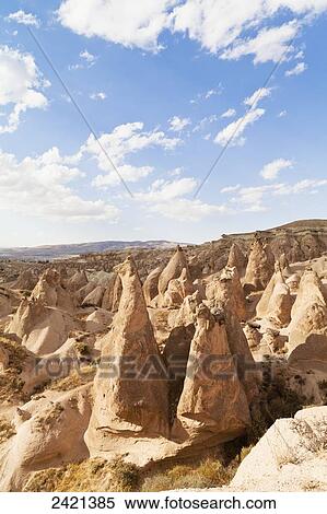 Stock Photography - Fairy chimneys and cliffs in a rugged, barren landscape in Deverent Valley; Cappadocia, Turkey. Fotosearch