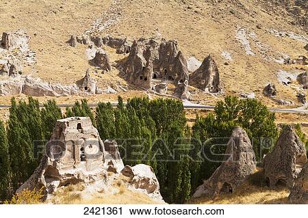 Fairy chimneys and trees in an arid landscape; Goreme, Cappadocia, Turkey View Large Photo Image Stock Image - Fairy chimneys and trees in an arid landscape; Goreme, Cappadocia, Turkey. Fotosearch