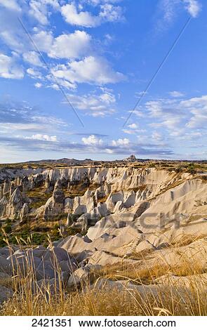 Fairy chimneys in the rugged, barren landscape of Honey Valley; Cappadocia, Turkey View Large Photo Image Stock Image - Fairy chimneys in the rugged, barren landscape of Honey Valley; Cappadocia, Turkey. Fotosearch