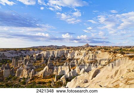 Fairy chimneys in the rugged, barren landscape of Honey Valley; Cappadocia, Turkey View Large Photo Image Stock Photo - Fairy chimneys in the rugged, barren landscape of Honey Valley; Cappadocia, Turkey. Fotosearch