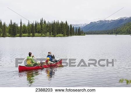 Family in red canoe on Byers Lake with green tree covered shoreline and mountain foothills in the background, Denali State Park; Alaska, Alaska, United States of America View Large Photo Image Stock Image - Family in red canoe on Byers Lake with green tree covered shoreline and mountain foothills in the background, Denali State Park; Alaska, Alaska, United States of America. Fotosearch