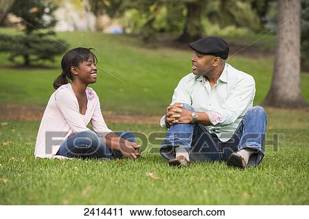 Stock Image - Father and daughter spending quality time together in a park; Edmonton, Alberta, Canada. Fotosearch