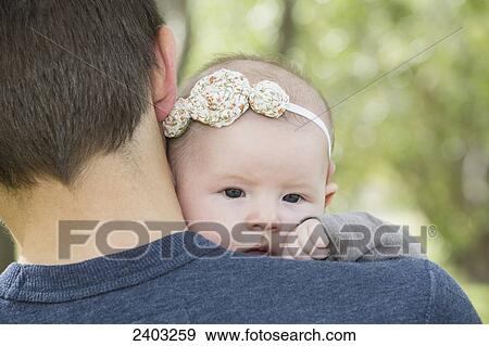 Stock Photo - Father and infant daughter in a park; Edmonton, Alberta, Canada. Fotosearch