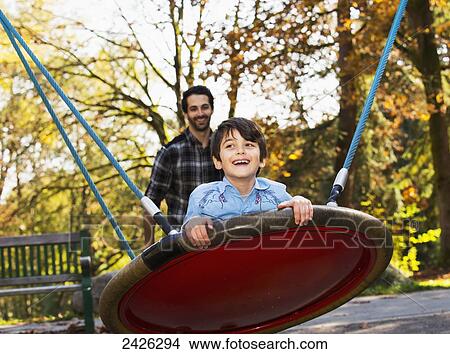 Father and son having fun together at a playground; Langley, British Columbia, Canada View Large Photo Image Picture - Father and son having fun together at a playground; Langley, British Columbia, Canada. Fotosearch