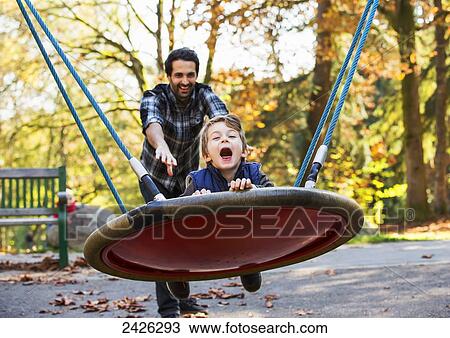 Father and son having fun together at a playground; Langley, British Columbia, Canada View Large Photo Image Stock Image - Father and son having fun together at a playground; Langley, British Columbia, Canada. Fotosearch