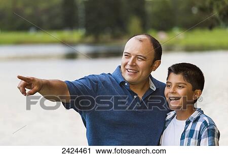 Father and son spending quality time together in a park; Edmonton, Alberta, Canada View Large Photo Image Stock Image - Father and son spending quality time together in a park; Edmonton, Alberta, Canada. Fotosearch