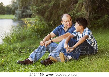 Stock Photo - Father and son spending quality time together in a park; Edmonton, Alberta, Canada. Fotosearch