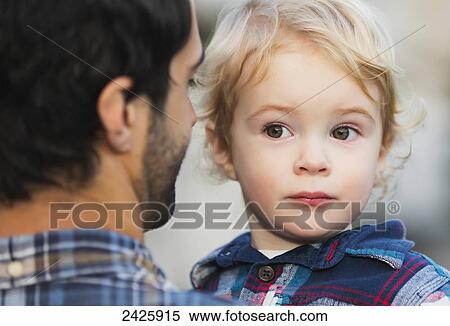 Stock Photography - Father carrying his young son; Langley, British Columbia, Canada. Fotosearch